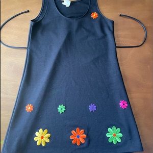 Cute 60s era dress. I believe the flowers are hand sewn. Ties in the back